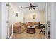 Comfortable living room with twin sofas, ceiling fan, and neutral walls, accessible through glass paneled double doors at 15608 Starling Water Dr, Lithia, FL 33547