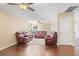 The living room features hardwood floors, a ceiling fan, and matching reclining sofas at 15608 Starling Water Dr, Lithia, FL 33547