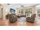 Living room with neutral paint, tile floors, ceiling fan, and large windows offering plenty of natural light at 15608 Starling Water Dr, Lithia, FL 33547