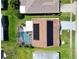 Overhead view of the home with solar panels, screened pool, and spacious backyard at 1575 Wicklow Dr, Palm Harbor, FL 34684