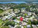 Aerial view of a community with a golf course, lake, and residential houses, marked with location pin at 1575 Wicklow Dr, Palm Harbor, FL 34684