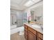 Bright bathroom with a tub and shower combo, marble countertop and traditional cabinet at 1575 Wicklow Dr, Palm Harbor, FL 34684