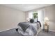 Sunlit bedroom featuring a stylishly dressed bed, decorative side tables, and a tranquil ambiance at 1575 Wicklow Dr, Palm Harbor, FL 34684