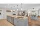 Open floorplan kitchen featuring a large island with sink and stainless appliances at 1575 Wicklow Dr, Palm Harbor, FL 34684