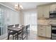 Eat-in kitchen featuring a dining table with access to the outside at 1575 Wicklow Dr, Palm Harbor, FL 34684