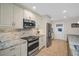 View of the kitchen featuring stainless appliances and granite countertops at 1575 Wicklow Dr, Palm Harbor, FL 34684