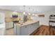 View of the kitchen featuring a large island with granite countertops and stainless appliances at 1575 Wicklow Dr, Palm Harbor, FL 34684