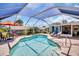 Sparkling pool surrounded by lounge chairs and lush landscaping, creating a private oasis at 1575 Wicklow Dr, Palm Harbor, FL 34684