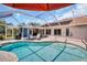Inviting pool area with covered lanai, chairs and open-air BBQ grill, ready for outdoor entertainment at 1575 Wicklow Dr, Palm Harbor, FL 34684