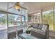 Comfortable sunroom with ceiling fan and view of the pool and backyard through screened windows at 1575 Wicklow Dr, Palm Harbor, FL 34684