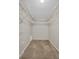 Spacious walk-in closet with wire shelving and carpeted flooring offering ample storage solutions at 1575 Wicklow Dr, Palm Harbor, FL 34684