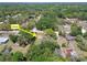 Aerial view of home nestled in a wooded neighborhood with mature trees at 16044 Stur St, Brooksville, FL 34604