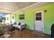 Comfortable and relaxing patio that is connected to the lawn and trees with plenty of comfortable furniture at 16044 Stur St, Brooksville, FL 34604