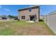 This backyard features a small patio with two grills, perfect for outdoor gatherings and summer barbecues at 16894 Delia St, Wimauma, FL 33598