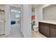 Bathroom with neutral walls, dark cabinets, soft lighting, with bedroom views at 16894 Delia St, Wimauma, FL 33598