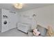 Bright Bedroom featuring a crib, comfortable chair, and lovely wall decor at 16894 Delia St, Wimauma, FL 33598