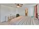 Comfortable bedroom with a ceiling fan, neutral carpet, a dresser and accent chair at 16894 Delia St, Wimauma, FL 33598