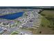The lakefront community is shown in an aerial view, featuring modern homes and beautiful water views at 16894 Delia St, Wimauma, FL 33598