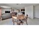 Open dining room with natural light and a view into the living room and kitchen at 16894 Delia St, Wimauma, FL 33598