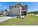Inviting two-story home with a two-car garage, landscaped front yard, and charming entryway, offering curb appeal at 16894 Delia St, Wimauma, FL 33598