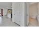Hallway view shows a kitchen with an island, walk-in pantry and a half bathroom at 16894 Delia St, Wimauma, FL 33598