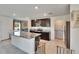 Bright kitchen features granite countertops, stainless steel appliances, and tiled flooring at 16894 Delia St, Wimauma, FL 33598
