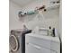 Efficient laundry room with front load washer, dryer, and shelving for ample storage at 16894 Delia St, Wimauma, FL 33598