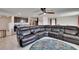 Open-concept living room with a plush sectional sofa, ceiling fan, and tiled floors at 16894 Delia St, Wimauma, FL 33598