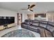 Open living area shows a living room flowing into the kitchen with tiled floors and modern lighting at 16894 Delia St, Wimauma, FL 33598