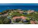 Stunning aerial view of waterfront condos surrounded by mature landscaping, ponds, tennis courts and ocean access at 1806 Mariner Dr # 112, Tarpon Springs, FL 34689