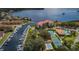 Waterfront condos with boat docks, tennis courts, swimming pool, parking, and mature trees, as seen from above at 1806 Mariner Dr # 112, Tarpon Springs, FL 34689
