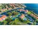 Scenic aerial view showcasing waterfront condos, tennis courts, swimming pools, and lush landscaping at 1806 Mariner Dr # 112, Tarpon Springs, FL 34689