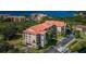 Stunning aerial view of the condo complex showcasing its red tile roofs, green spaces, and waterfront location at 1806 Mariner Dr # 112, Tarpon Springs, FL 34689