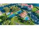 Aerial view of community tennis courts, pools, and parking lot at 1806 Mariner Dr # 112, Tarpon Springs, FL 34689