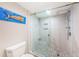 Beautifully updated bathroom featuring a glass shower enclosure, mosaic tile floor, and designer accents at 1806 Mariner Dr # 112, Tarpon Springs, FL 34689
