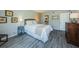 Bedroom features a queen bed, wood floors, and neutral paint, creating a serene and inviting atmosphere at 1806 Mariner Dr # 112, Tarpon Springs, FL 34689