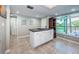 Kitchen with island, granite countertops, white cabinets, and natural light at 1806 Mariner Dr # 112, Tarpon Springs, FL 34689