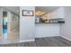 Updated kitchen with breakfast bar, stainless appliances and gray laminate flooring at 1806 Mariner Dr # 112, Tarpon Springs, FL 34689