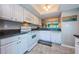 Well-lit kitchen showcasing white appliances and granite countertops at 1806 Mariner Dr # 112, Tarpon Springs, FL 34689