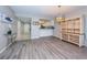 Spacious living room with laminate flooring and kitchen view at 1806 Mariner Dr # 112, Tarpon Springs, FL 34689