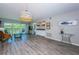 Open living space with balcony access, laminate flooring and wet bar at 1806 Mariner Dr # 112, Tarpon Springs, FL 34689