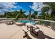 Inviting outdoor patio with picnic tables and comfortable seating, providing a relaxing space by the pool at 1806 Mariner Dr # 112, Tarpon Springs, FL 34689
