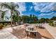 Community patio with seating and grills set against a lush backdrop of palm trees and manicured landscaping at 1806 Mariner Dr # 112, Tarpon Springs, FL 34689