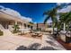 A delightful outdoor patio with seating, umbrellas, and a stainless steel grill for community gatherings at 1806 Mariner Dr # 112, Tarpon Springs, FL 34689