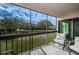 Peaceful screened lanai featuring comfortable seating and views of the beautifully landscaped grounds at 1806 Mariner Dr # 112, Tarpon Springs, FL 34689