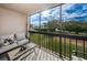 Cozy screened porch with comfortable seating and views of the lush green landscape at 1806 Mariner Dr # 112, Tarpon Springs, FL 34689