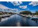 Picturesque waterfront view featuring serene water, boat docks, and charming residential buildings under a sunny sky at 1806 Mariner Dr # 112, Tarpon Springs, FL 34689