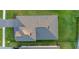 Aerial view of the house roof, backyard with healthy green lawn and beautiful brick paver driveway at 19475 Bristol Wood Pl, Brooksville, FL 34601