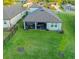 View of the house’s backyard, showing a covered patio and a well-maintained lawn at 19475 Bristol Wood Pl, Brooksville, FL 34601