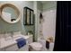 Bright bathroom featuring a shower-tub combo, stylish vanity, and decorative wall shelving at 19475 Bristol Wood Pl, Brooksville, FL 34601